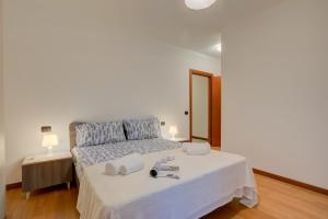 a bedroom with a bed with two towels on it at Magnolia - Happy Rentals in Laveno-Mombello
