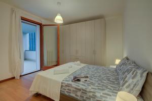 a bedroom with a bed with a towel on it at Magnolia - Happy Rentals in Laveno-Mombello