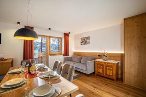 - un salon avec une table et un canapé dans l'établissement App Hubertus - Moosstock, à Sand in Taufers