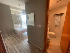 a bathroom with a toilet and a room with a bed at 2-bedroom & 3 bath in Dubai Marina & 5 min walking to JBR in Dubai
