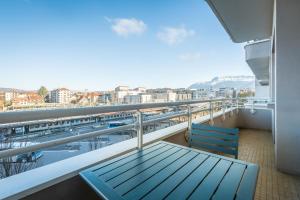 a balcony with a bench and a view of the city at La station n° 5 in Annecy