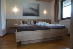 a bedroom with a bed with two towels on it at Ferienhaus Edith in Kaltenbach