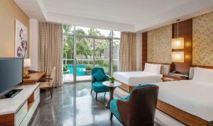 a hotel room with a bed and a television at MGM Grand Sanya in Sanya