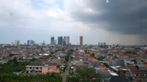 a view of a city with buildings in the background at Best Choice 2BR at Puncak Permai Apartment Surabaya By Travelio in Surabaya