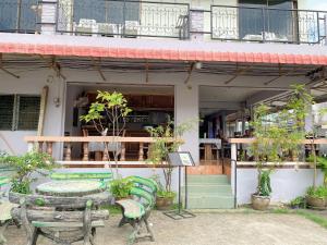 a table and chairs in front of a building at 2 Vikings Guesthouse in Karon Beach