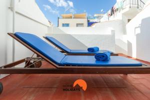 een bed op een balkon met blauwe handdoeken bij #197 Villa Old Town on the Beach in Albufeira