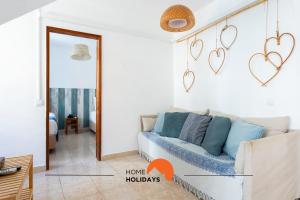 a living room with a couch and hearts on the wall at #197 Casa Gili by Home Holidays in Albufeira +65 photos