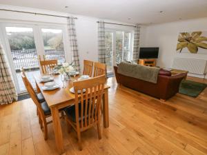 sala de estar con mesa, sillas y sofá en Heron, en Milford Haven