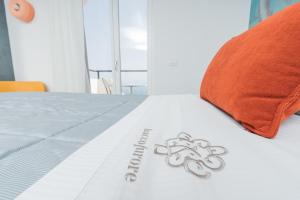 a comforter with a flower on a bed with a pillow at Albergo Dipinto BaccoFurore in Furore
