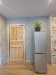 a room with a refrigerator and a door with a potted plant at New apartment in historic house in Riga