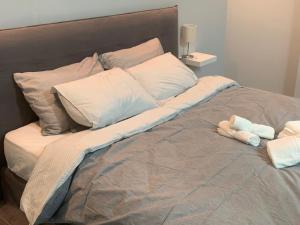 a large bed with a stuffed animal on it at Academys Modern Apartment by Aesthetic & Luxurious in Athens