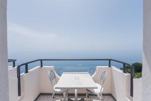 a table and chairs on the balcony of a building at Albergo Dipinto BaccoFurore in Furore