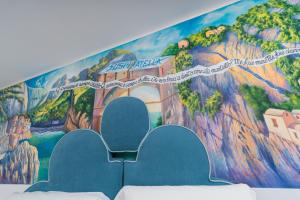 a wall with a mural of a mountain at Albergo Dipinto BaccoFurore in Furore