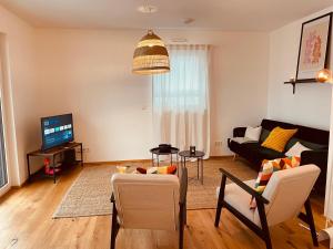 a living room with a couch and a tv at Wohlfühloase in Worms