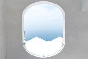 an oval window with a view of the ocean at Albergo Dipinto BaccoFurore in Furore