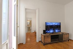 un salon avec une télévision à écran plat sur une table dans l'établissement Amazing Lugano - Happy Rentals, à Lugano