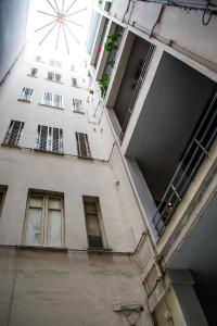 a tall white building with windows and a stairway at Miracolo al Duomo Smart Accomodations in Naples