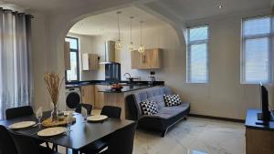 a kitchen and living room with a table and a couch at Residence Oceana 4 in Mont Choisy