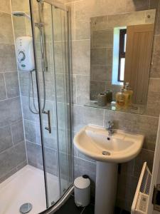 a bathroom with a shower and a sink and a shower at Cosy & Characterful, Seaside Cottage, Dog Friendly in Worle
