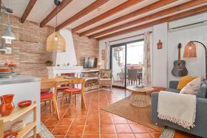 a kitchen and a living room with a table at Apartment private swimming pool in Frigiliana