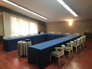 a large blue table in a room with chairs at Hotel Restaurante El Montico in Tordesillas +33 photos