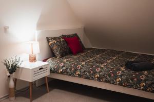 a small bedroom with a bed and a night stand at Viljandi Jahiloss in Viljandi