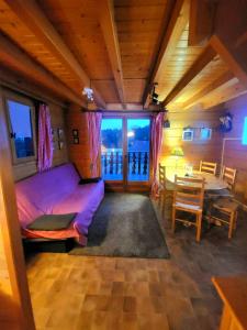 a bedroom with a bed and a dining room with a table at Maison de bois finlandaise au pied des pistes in Bolquere Pyrenees 2000