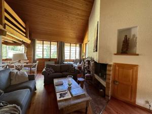 a living room with a couch and a table at Chalet Rossier Mayens de Sion aux 4 Vallées in Agettes