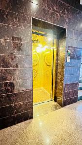 a bathroom with a yellow door in a brick wall at Nahargarh Palace Hotel in Jaipur