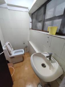 La salle de bains est pourvue d'un lavabo et de toilettes. dans l'établissement HOTEL THAKUR SHRI , BHOPAL, à Bhopal