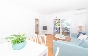 a living room with a couch and a table at Villa Jomar by Sonne Villas in Cala Galdana