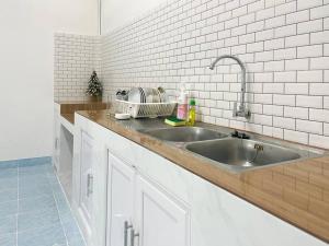 a kitchen with a sink and a counter top at Rainhill@Betong in Betong