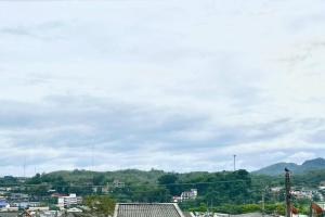 a view of a city with mountains in the background at Rainhill@Betong in Betong