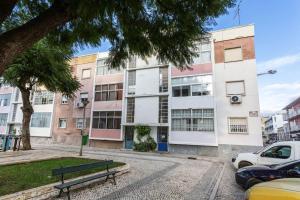 a park bench in front of a building at BLife Farensya private rooms in Faro