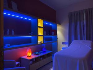 a bedroom with a bed with blue lights on it at Hotel Butterfly Wellness & Spa in Rimini