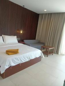a bedroom with a large bed and a couch at Beach house by Rose massage in Nai Thon Beach