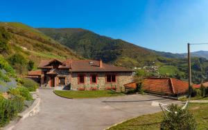 a house in the middle of a mountain at Posada Real Pajares in Pajares