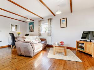 a living room with a couch and a tv at 1 Bed in Sennen GIDUP in St Just