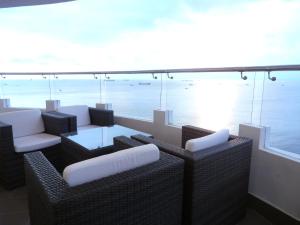 a balcony with a table and chairs and the ocean at Amazing Seaview - Thuy Tien Building in Vung Tau