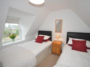 a bedroom with two beds and a window at 2 bed in Huntly AB171 in Huntly