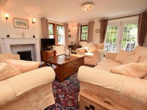 a living room with two couches and a fireplace at 5 Bed in Castle Douglas KK169 in Castle Douglas