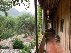 a balcony of a house with a view of a garden at Ham Rong Bungalow in Xuân Sơn