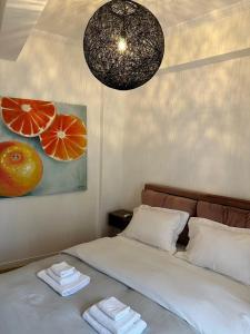 a bedroom with a bed and a painting of oranges at Cozy Apartment at Gazi Square in Athens