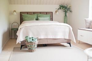 a bedroom with a bed with green pillows at SalviaMontis in Kamienna Góra