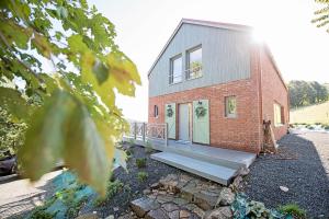 a brick house with a staircase leading up to it at SalviaMontis in Kamienna Góra +21 photos