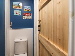 a bathroom with a toilet and a wooden door at Number Seventeen in Amble +15 photos