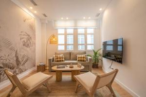 a living room with a couch and a table at XPCE Cathedral - Luxury Flat in Málaga