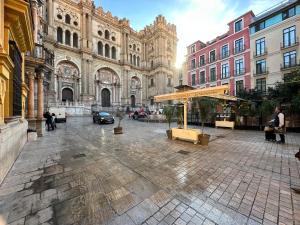 a large building with people walking in front of it at XPCE Cathedral - Luxury Flat in Málaga