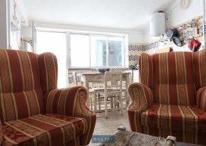 sala de estar con 2 sillas y mesa en MyStay - Casa dos Parentes, en Igrejinha