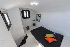 a room with a black table with colorful pillows on it at The Luna Suite with jacuzzi in Emporio Santorini
